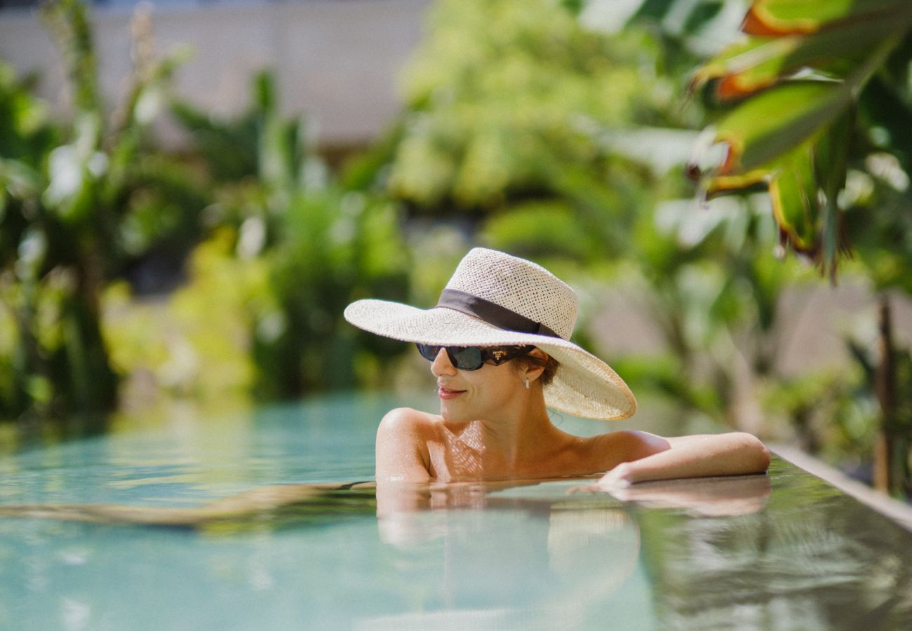 Freshwater pool set on Indian green marble flooring, heated to 35ºC, surrounded by lush vegetation and banana trees